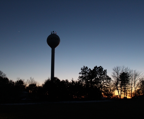 Small town water tower at sunset