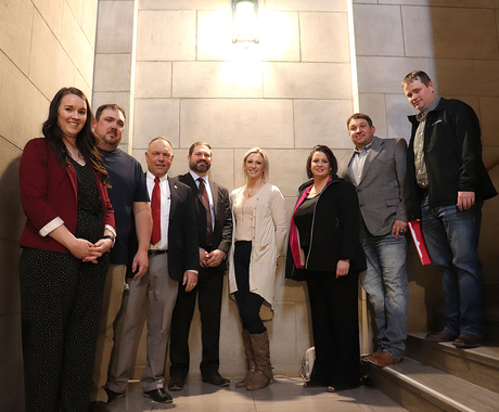 Several individuals pose on staircase at Nebraska state capital