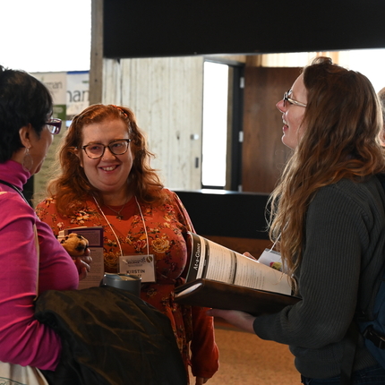 Three women networking at a conference