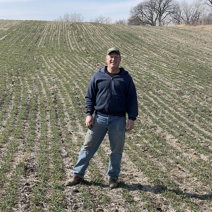 Bruce Willems standing in a field