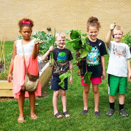 Children holding up lettuce