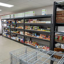 Food pantry shelves in a bright room.