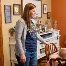 Mikaela Wolfe standing at the table in her day care