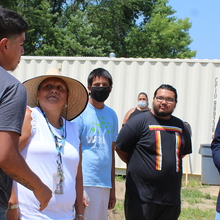 High school students and teacher in a garden hat greeting Nebraska governor in a garden