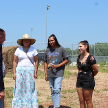 Female high school students greeting Nebraska governor in a garden
