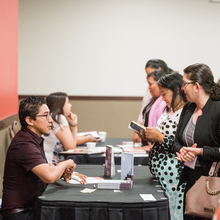 People visiting booths at conference