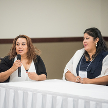 Two women speaking at conference