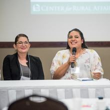 Two women speaking at conference