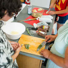 Woman showing student how to cut sage