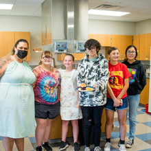 Woman and students pose for photo