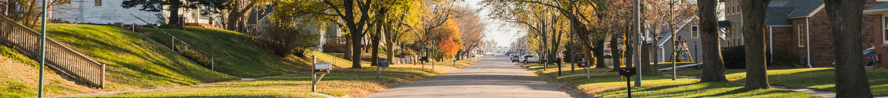 Looking down a residential street in a small town during the fall