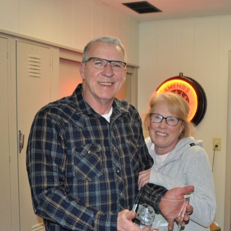 An image of a couple holding an award