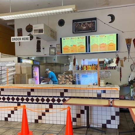 An image of a man behind the counter of a restaurant