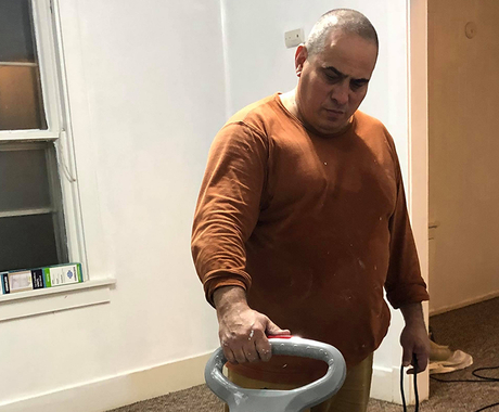 man deep cleaning carpet
