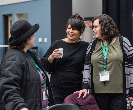 Three women networking at a conference