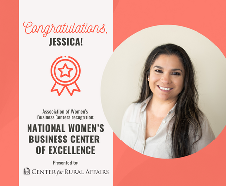 A graphic with a salmon background that says "Congratulations, Jessica! Association of Women's Business Centers recognition: National Women's Business Center of Excellence Presented to: Center for Rural Affairs." To the right of the text, there is a circular headshot of a woman smiling at the camera. She has long, dark, straight hair and is wearing a grey button-down shirt.