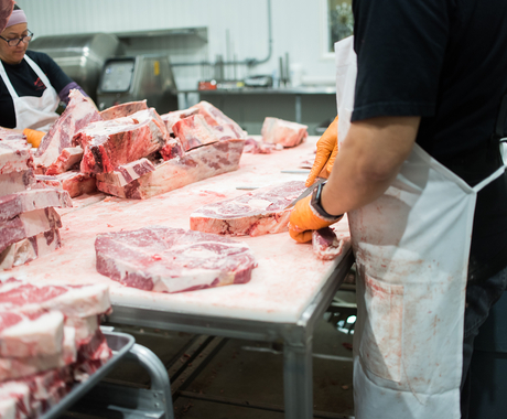 Employees processing meat 