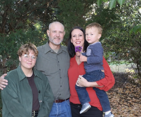 Family of four poses for picture