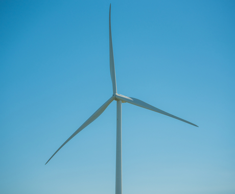 Wind turbine with blue sky in the background.