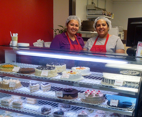Two women behind bakery counter