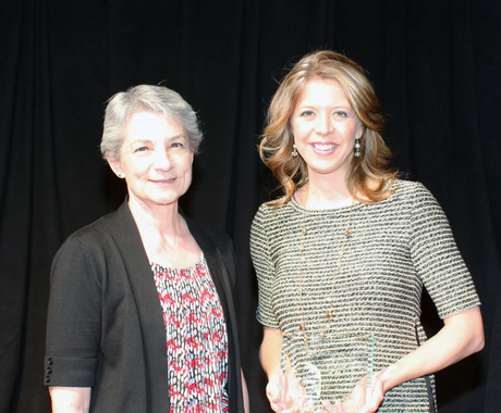 Two women holding a plaque