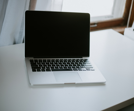 apple laptop on white desk