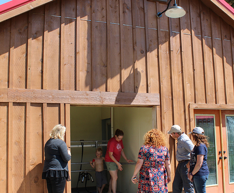 Group of people in front of milking barn