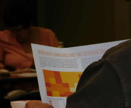 Looking over someone's shoulder at a health care fact sheet
