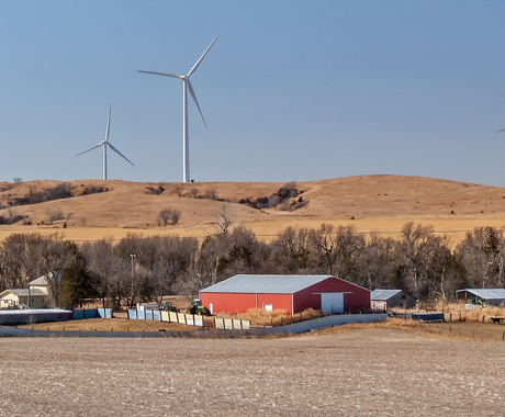 Farm place with wind towers in background