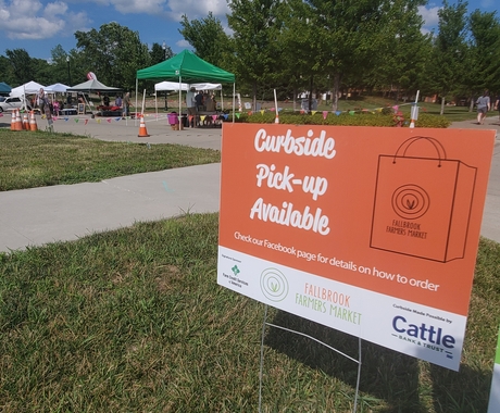 sign for curbside pick-up availability at farmers market