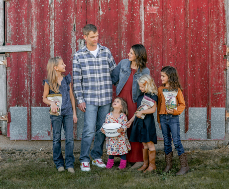 Family with popcorn posing for photo