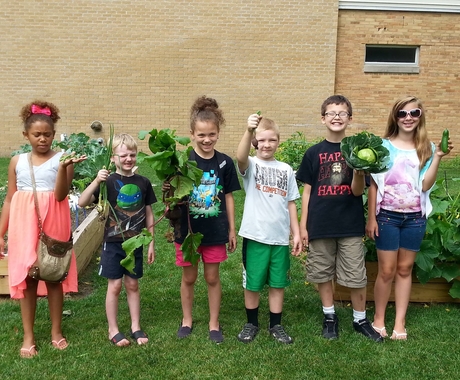 Children holding vegetables