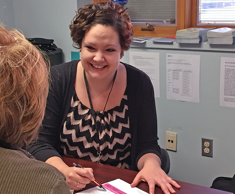 Woman helping others at desk