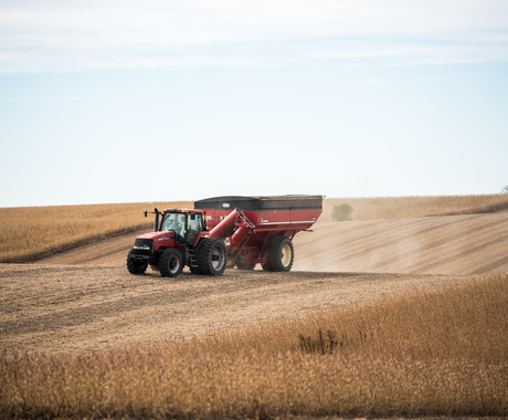 Tractor with grain cart during harvest