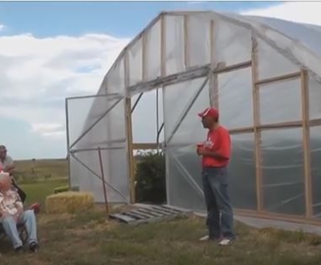 Man just outside greenhouse