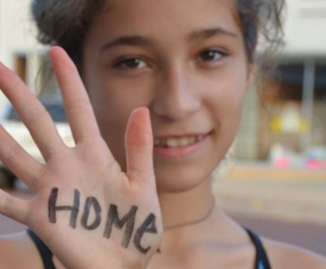 Girl with "home" written on her hand