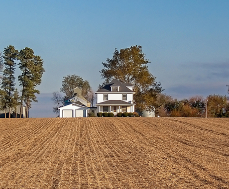 Rural home with harvested field out front