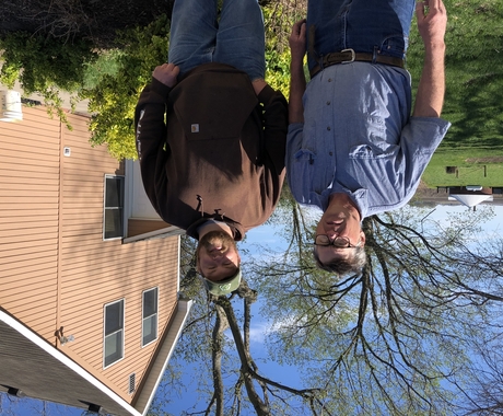 Two men in front of farm house