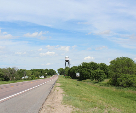 Highway going into town with a water tower in the background