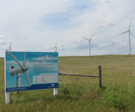 Sign for wind energy facility with wind turbines behind