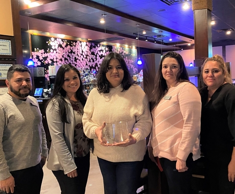 group of people posing with award
