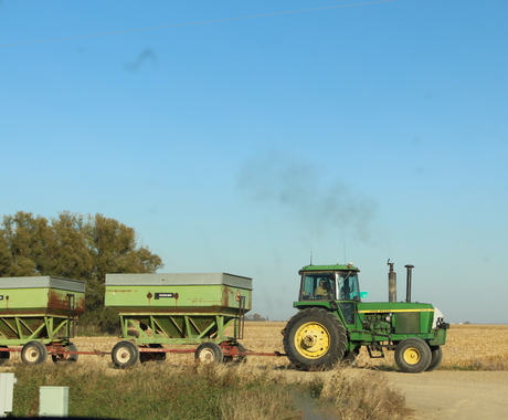 Tractor with grain cart during harvest