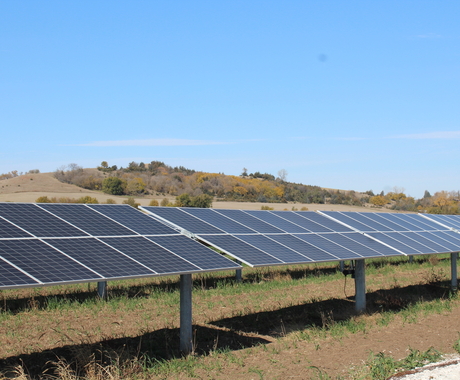 Solar arrays at a public power owned solar farm, with hills behind