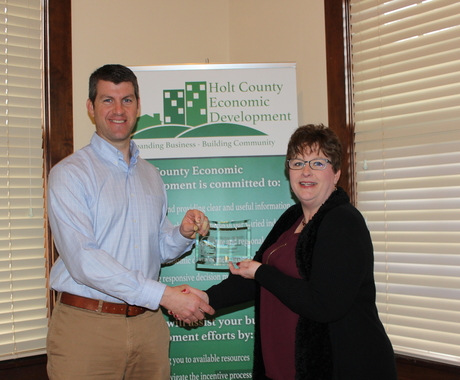 Man receiving award from woman