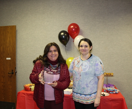 Woman receiving award from other woman