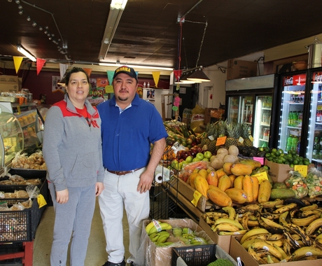 Woman and man business owners in grocery store