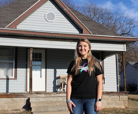 Woman standing in front of house