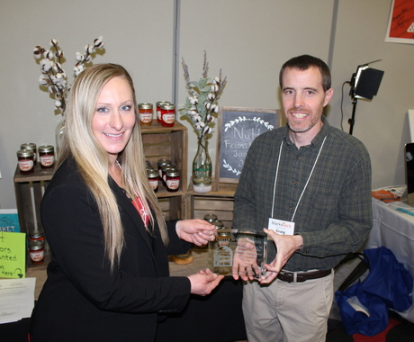 Woman and man with award