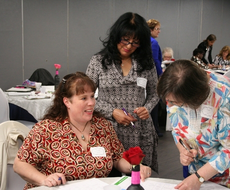 Three women networking at a table