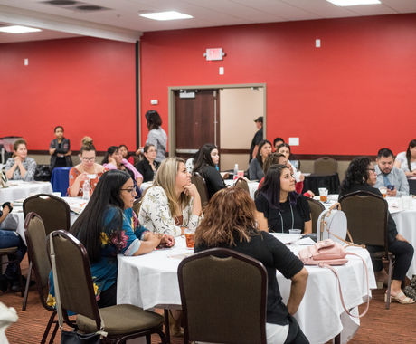 Conference hall with people seated at tables